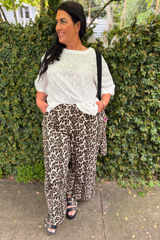 Bianca, NZ size 16 in a size L, wearing the Sahara Barrel Jeans in Leopard with the Luna Top in Coconut broderie, front view — Libertine The Label