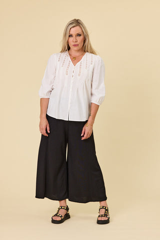 Voyager wide-leg pants in black stretch fabric with blanket stitch hem | Libertine The Label