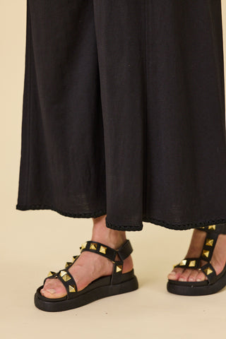 Voyager wide-leg pants in black stretch fabric with blanket stitch hem | Libertine The Label
