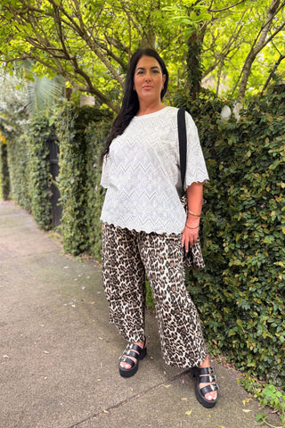 Bianca wearing the Luna Top in Coconut broderie with the Sahara Barrel Jeans in Leopard, full length, showing the darted barrel leg and deep turn-up cuff — Libertine The Label