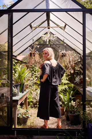 Voyager jumpsuit in black stretch fabric with elasticated cape and blanket stitch | Libertine The Label