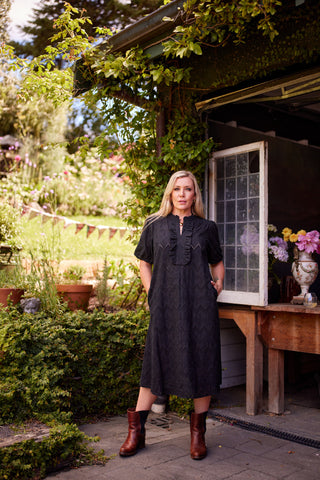 Belle Dress in black broiderie, side view showing A-line silhouette — Libertine The Label