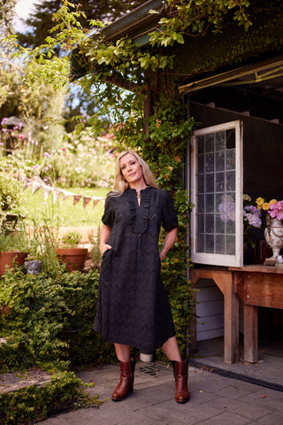 Belle Dress in black broiderie, close-up of ruffled neckline — Libertine The Label