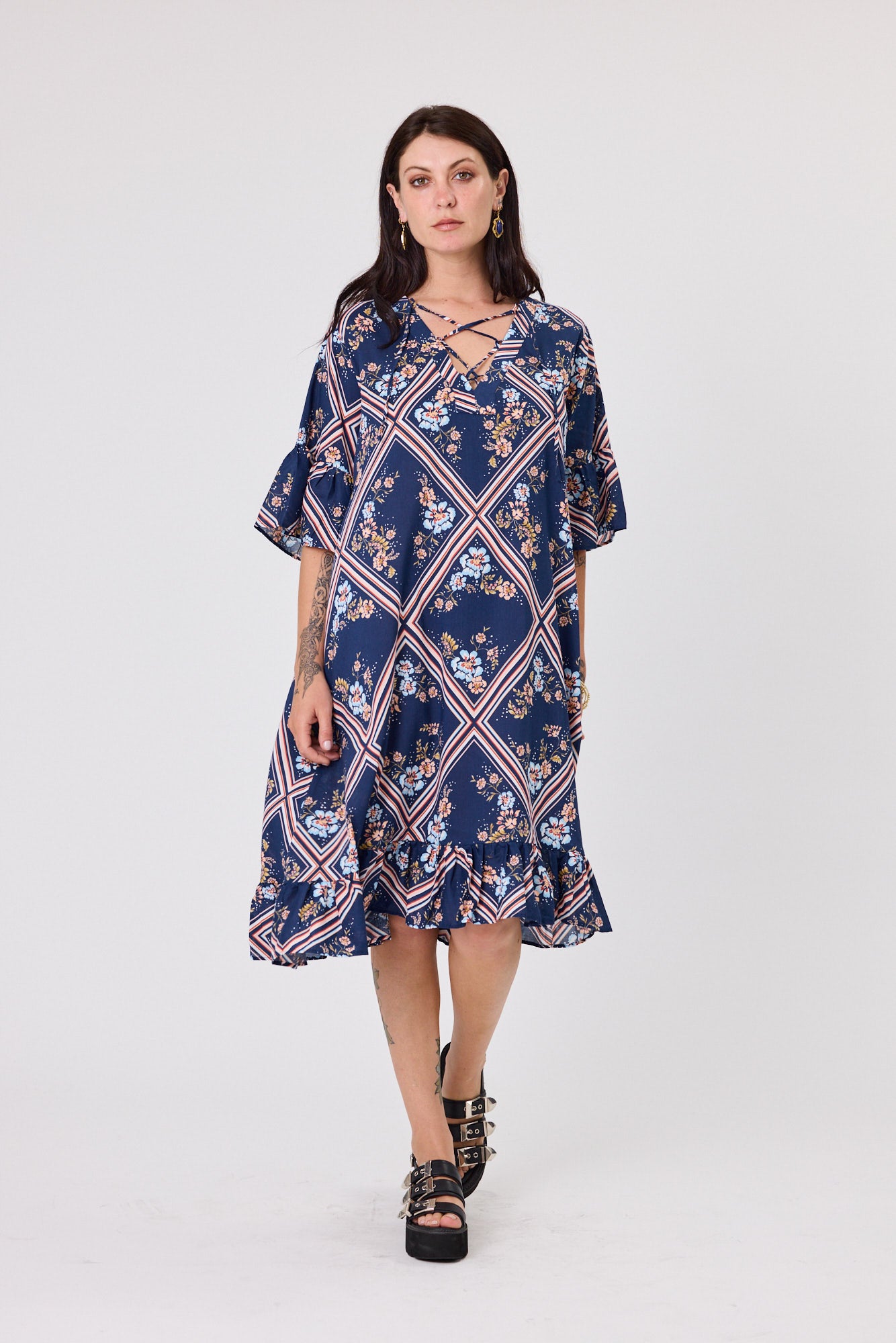 Woman wearing a blue floral dress on a white background