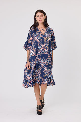 Woman wearing a blue floral dress on a white background