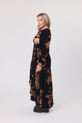 Woman wearing a black floral dress on a white background