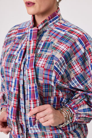 Close-up of a woman wearing a stylish french tartan blouse with colorful plaid