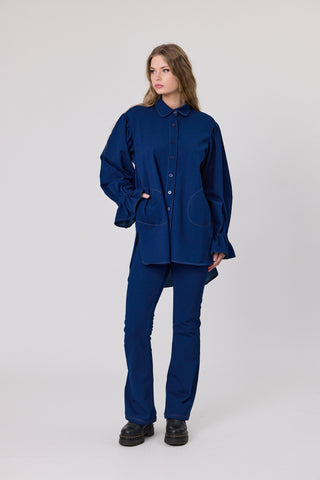woman wearing denim knit shirt with side pockets and pull on denim knit leggings