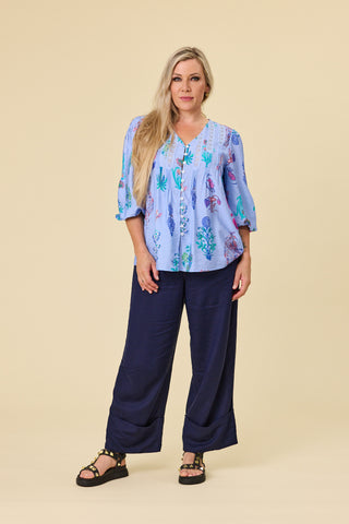 Evana wearing the Atlas Blouse in Sky botanical print with crochet lace V-neck — Libertine The Label
