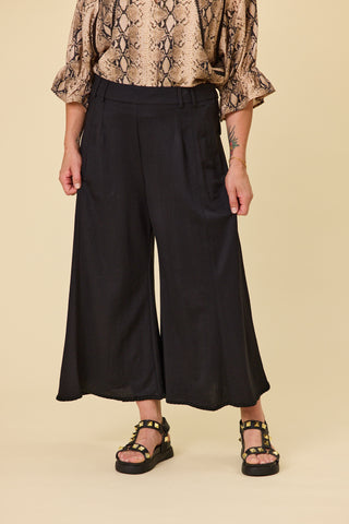 Voyager wide-leg pants in black stretch fabric with blanket stitch hem | Libertine The Label