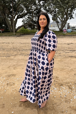Bianca, NZ size 16, wearing the Sienna Dress in indigo shibori in our size L, hands in the side pockets | Libertine The Label