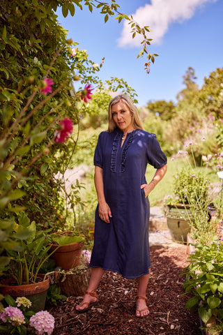 Belle Dress in indigo, side view showing full A-line silhouette and white contrast stitching — Libertine The Label