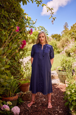 Belle Dress in indigo, full-length garden shot with pockets and puff sleeves — Libertine The Label
