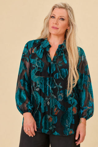 woman in burn out velvet teal blouse with shirred collar and balloon sleeves