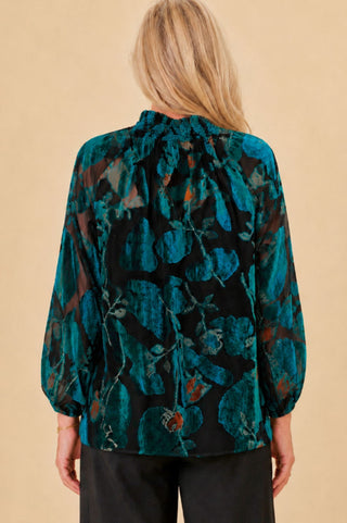 woman in burn out velvet teal blouse with shirred collar and balloon sleeves