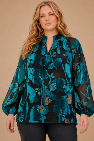 plus size woman in burn out velvet teal blouse with shirred collar and balloon sleeves