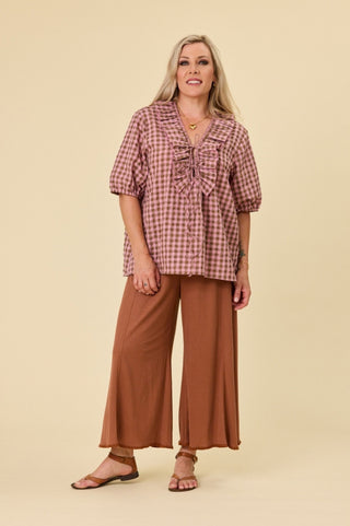 Full length studio shot of the Poet blouse in marshmallow and choc latte seersucker, showing the V ruffle neckline, neck ties and relaxed body.