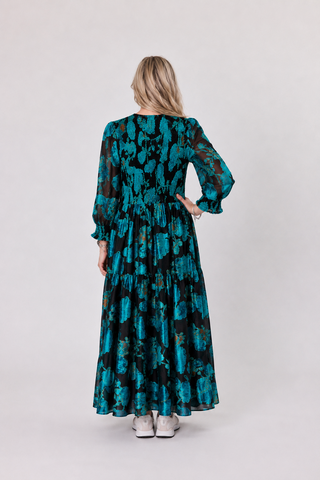 woman in teal black burn out 
velvet maxi dress
