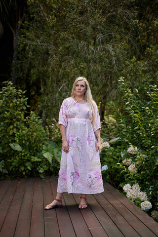 Evana, NZ size 12 in a size S, wearing the Devotion Dress in Marshmallow, pink ramie embroidered all over in flowers, in a garden — Libertine The Label