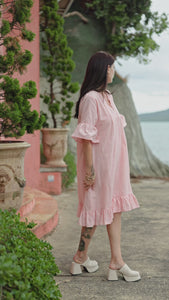 wman in melon and white stripe dress