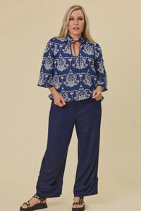 Woman wearing devotion blouse indigo + sahara pants indigo Libertine the label