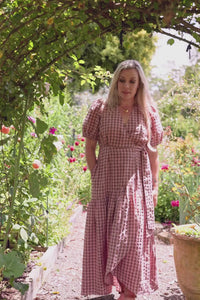 Video of a woman wearing the Wyatt wrap maxi dress in marshmallow and choc latte seersucker cotton, showing how the hem frill and three-quarter sleeves move as she walks.