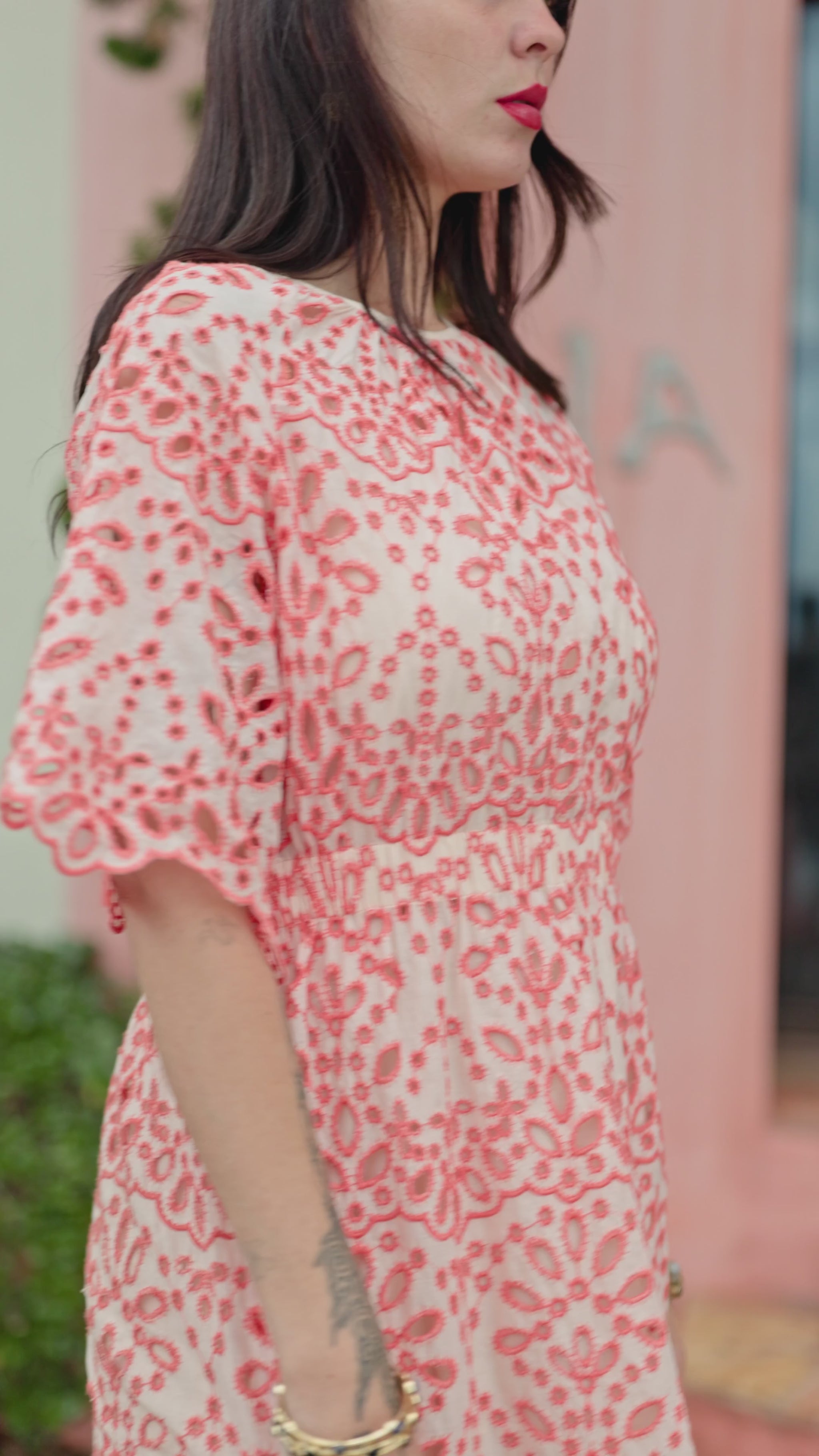 woman walking in melon lace dress