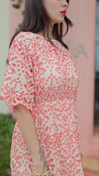 woman walking in melon lace dress
