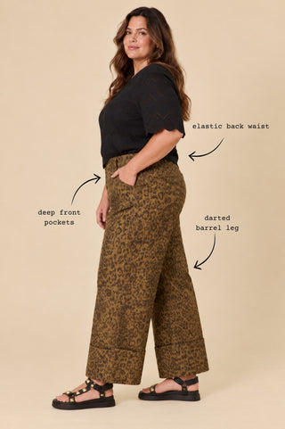 Side view of the Sahara Barrel Jeans in Panther on Jorja, NZ size 16 in a size L, showing the elastic back waist, deep front pockets and darted barrel leg — Libertine The Label