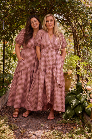 Two women wearing the same marshmallow and choc latte seersucker wrap maxi dress side by side, in different sizes.